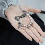 スピンコニカルパールクロスブレスレット / Spin Conical Pearl Cross Bracelet