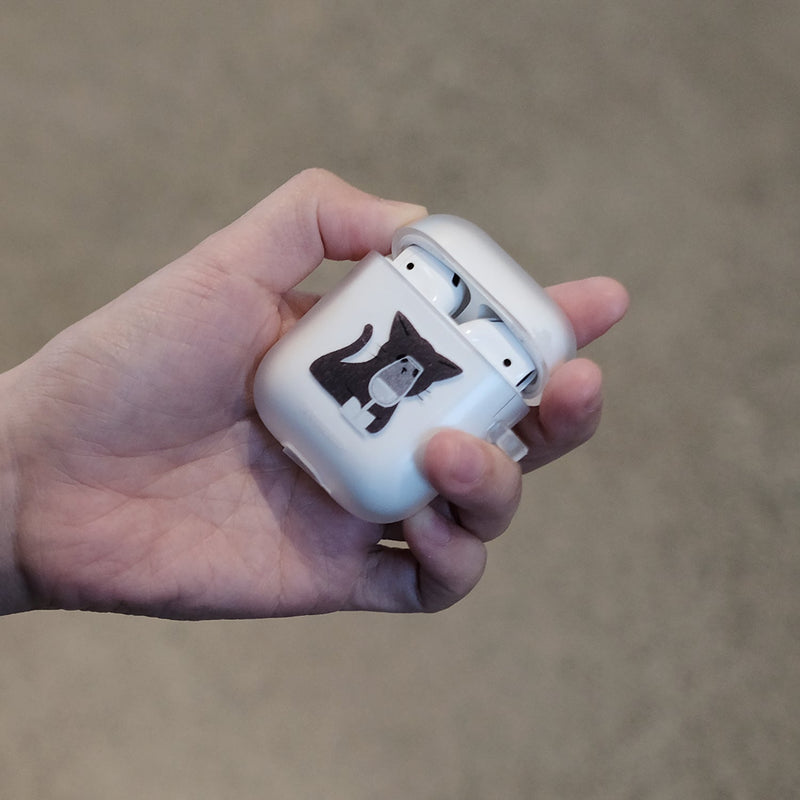 Cat holding a glass Airpods case